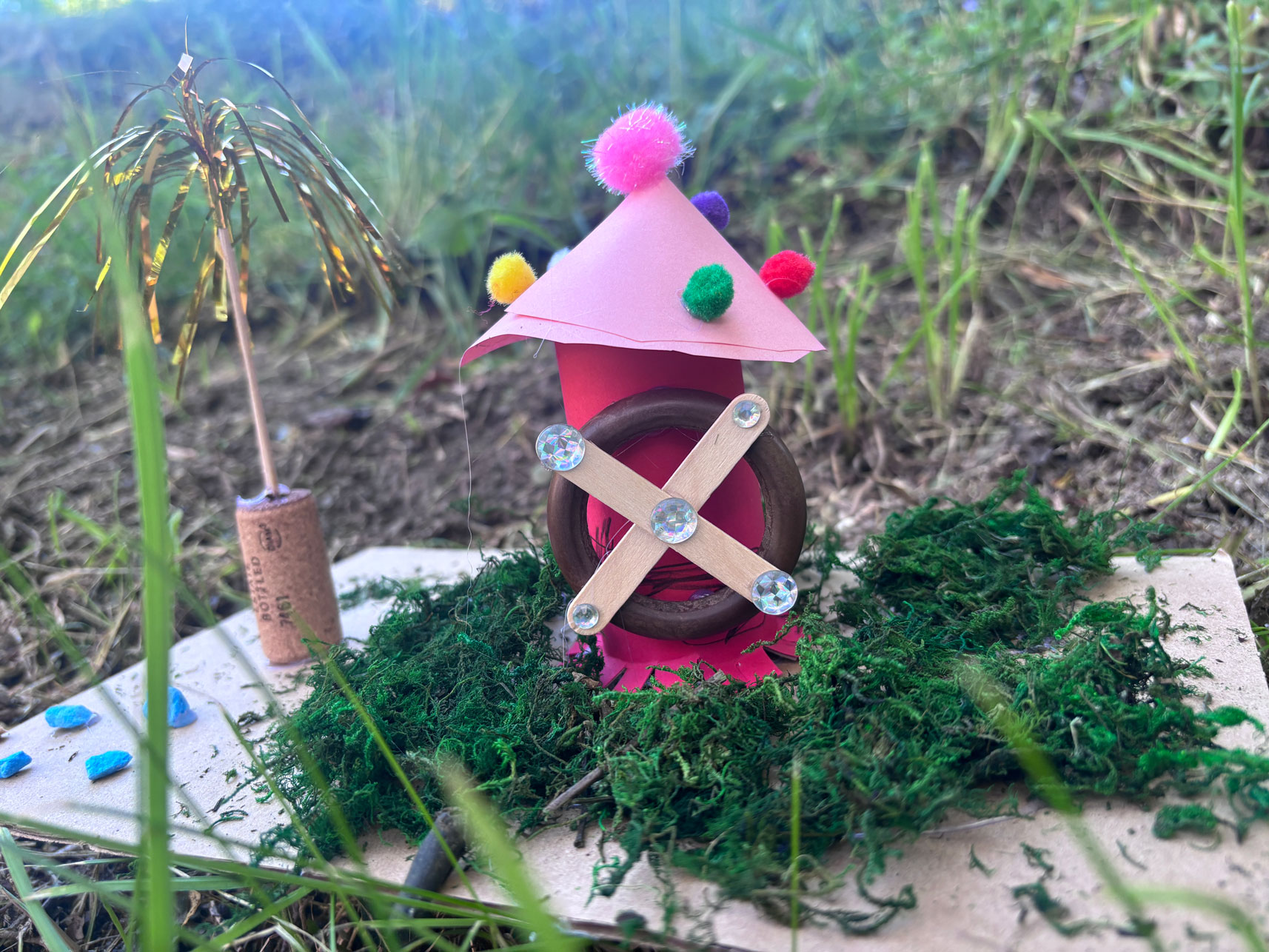 Mühle aus Pappe mit Holzstäbchen als Mühlrad